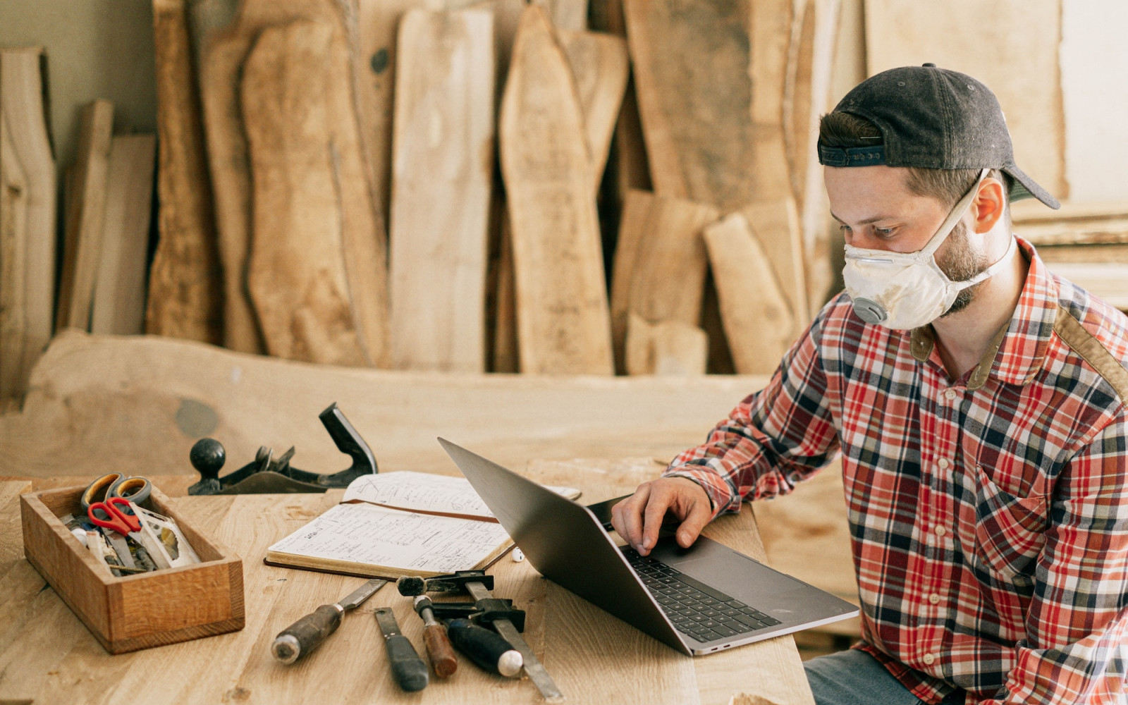 Image of carpenter working on laptop